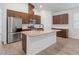 Features a kitchen island with granite countertops, stainless steel appliances, and dark wood cabinets at 12009 Walmsley Aly, Winter Garden, FL 34787