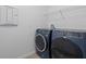 Laundry room featuring front loading washer and dryer with overhead wire shelving at 12009 Walmsley Aly, Winter Garden, FL 34787