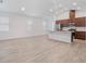 An open floorplan with a large living room featuring modern tile flooring adjacent to the kitchen at 12009 Walmsley Aly, Winter Garden, FL 34787