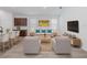 Bright, neutrally decorated living room adjacent to the kitchen with bar seating at the kitchen island at 12009 Walmsley Aly, Winter Garden, FL 34787