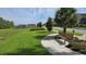 A bench under a shade tree overlooks a verdant park area, offering a space for relaxation and enjoyment at 12009 Walmsley Aly, Winter Garden, FL 34787