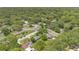 High aerial view of homes nestled among lush trees in a quiet neighborhood, showcasing their serene surroundings at 1202 Randolph St, Sanford, FL 32771