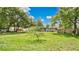 Spacious backyard with a lush green lawn and mature trees, perfect for outdoor activities and relaxation at 1202 Randolph St, Sanford, FL 32771