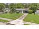 Well-kept home featuring a manicured lawn, charming curb appeal, and a welcoming screened-in porch at 1202 Randolph St, Sanford, FL 32771