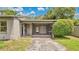 Close up of the screened in front porch with address number and small ornamental tree at 1202 Randolph St, Sanford, FL 32771