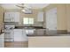 This kitchen is equipped with white appliances, laminate countertops, and ample cabinet space at 1202 Randolph St, Sanford, FL 32771