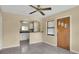 Living room shows the entrance door and a view of the white cabinets in the kitchen at 1202 Randolph St, Sanford, FL 32771