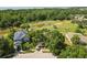 Aerial view of home with solar panels, mature trees, and water view at 1227 Juniper Hammock St, Winter Garden, FL 34787