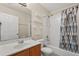 Well-lit bathroom with vanity, shelves, tub, and shower combo at 1227 Juniper Hammock St, Winter Garden, FL 34787