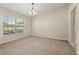 Neutral bedroom with vaulted ceiling, large window bringing in ample natural light, and neutral carpet at 1227 Juniper Hammock St, Winter Garden, FL 34787