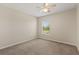 The carpeted bedroom has neutral paint and ceiling fan for added comfort at 1227 Juniper Hammock St, Winter Garden, FL 34787