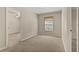 This carpeted bedroom has an adjoining door and window providing natural light at 1227 Juniper Hammock St, Winter Garden, FL 34787