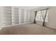 Bonus room featuring a large built-in bookshelf, a window, and neutral colored carpet at 1227 Juniper Hammock St, Winter Garden, FL 34787