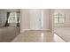 Bright foyer featuring neutral walls, a white front door with sidelight, and easy access to the living spaces at 1227 Juniper Hammock St, Winter Garden, FL 34787
