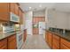Well-equipped kitchen with modern appliances, oak cabinets, tiled backsplash, and plenty of counter space at 1227 Juniper Hammock St, Winter Garden, FL 34787
