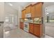 Open kitchen featuring modern appliances, oak cabinetry, and breakfast bar with views of the living area at 1227 Juniper Hammock St, Winter Garden, FL 34787