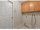 Functional laundry room with upper cabinets and essential hookups at 1227 Juniper Hammock St, Winter Garden, FL 34787