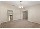 Cozy living room with neutral walls, neutral carpet, and views of the kitchen and hallways at 1227 Juniper Hammock St, Winter Garden, FL 34787