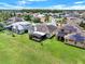 Aerial view of the property showcasing a spacious backyard, screened lanai, and well-maintained landscaping at 14036 Cherry Bush Ct, Orlando, FL 32828