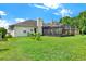 Expansive backyard showcasing a screened-in patio, providing ample space for relaxation and entertainment at 14036 Cherry Bush Ct, Orlando, FL 32828