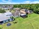 Aerial view of the rear of a home, displaying a pristine, green lawn with a screened in patio at 14036 Cherry Bush Ct, Orlando, FL 32828