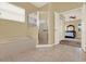 A primary bathroom with a bathtub, shower, and a doorway to the bedroom at 14036 Cherry Bush Ct, Orlando, FL 32828