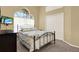 This guest bedroom features a comfortable bed, large window, and neutral walls at 14036 Cherry Bush Ct, Orlando, FL 32828