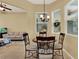 Cozy breakfast nook with a round table, decorative chairs, and windows providing natural light, adjacent to living room at 14036 Cherry Bush Ct, Orlando, FL 32828