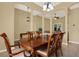 Open dining area with a large wooden table, elegant chairs, and arched entryways to the living room and kitchen at 14036 Cherry Bush Ct, Orlando, FL 32828