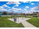 Outdoor exercise area featuring workout equipment, a paved path, and scenic views of the pond and surrounding community at 14036 Cherry Bush Ct, Orlando, FL 32828