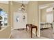 Inviting foyer with double doors, tile flooring, a decorative light fixture, and a glimpse into the adjacent bedroom at 14036 Cherry Bush Ct, Orlando, FL 32828