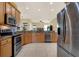 Gourmet kitchen with stainless steel appliances and granite countertops, with views to the living area at 14036 Cherry Bush Ct, Orlando, FL 32828