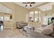 Open-concept living room with tile floors, neutral decor, and views into the dining area and kitchen at 14036 Cherry Bush Ct, Orlando, FL 32828