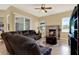 Inviting living room with a fireplace and a large leather sofa, featuring neutral colors at 14036 Cherry Bush Ct, Orlando, FL 32828