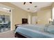 This is a primary bedroom that features a ceiling fan, sliding glass door, and neutral walls at 14036 Cherry Bush Ct, Orlando, FL 32828