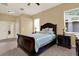 This is a main bedroom with carpet, a ceiling fan, and large windows at 14036 Cherry Bush Ct, Orlando, FL 32828