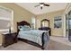 This is a primary bedroom with a ceiling fan, carpet, and a large dresser at 14036 Cherry Bush Ct, Orlando, FL 32828