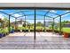 View from the screened in lanai to the lush green lawn and neighboring properties at 14036 Cherry Bush Ct, Orlando, FL 32828