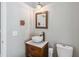 A half-bathroom features a vessel sink, modern fixtures, and a warm wooden vanity at 14205 Conifer Dr, Orlando, FL 32832