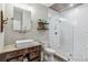 Charming bathroom with a tiled shower, a unique vanity, and storage at 14205 Conifer Dr, Orlando, FL 32832