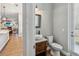 A stylish half-bathroom features a vessel sink, modern fixtures, and a door to the backyard at 14205 Conifer Dr, Orlando, FL 32832