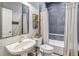 Bathroom featuring a pedestal sink, tiled shower-tub combination, and neutral color palette at 14205 Conifer Dr, Orlando, FL 32832
