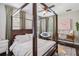 Comfortable bedroom with a four-poster bed and natural light at 14205 Conifer Dr, Orlando, FL 32832
