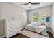 Cozy bedroom features natural light, trundle bed, dresser, and decorative elements at 14205 Conifer Dr, Orlando, FL 32832