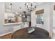 Dining area is connected to the kitchen, features a round table, and a stylish light fixture at 14205 Conifer Dr, Orlando, FL 32832