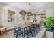 Dining room with live edge table, woven pendants, and views into the living room at 14205 Conifer Dr, Orlando, FL 32832