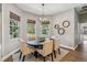 Dining room featuring a round table, modern chandelier, and bright natural light at 14205 Conifer Dr, Orlando, FL 32832