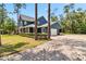 Charming blue home features a two-car garage and long paved driveway at 14205 Conifer Dr, Orlando, FL 32832