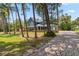 Charming blue home boasts a long, paved driveway and well-maintained landscaping at 14205 Conifer Dr, Orlando, FL 32832