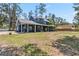 Stunning blue exterior of home with large backyard and mature trees at 14205 Conifer Dr, Orlando, FL 32832